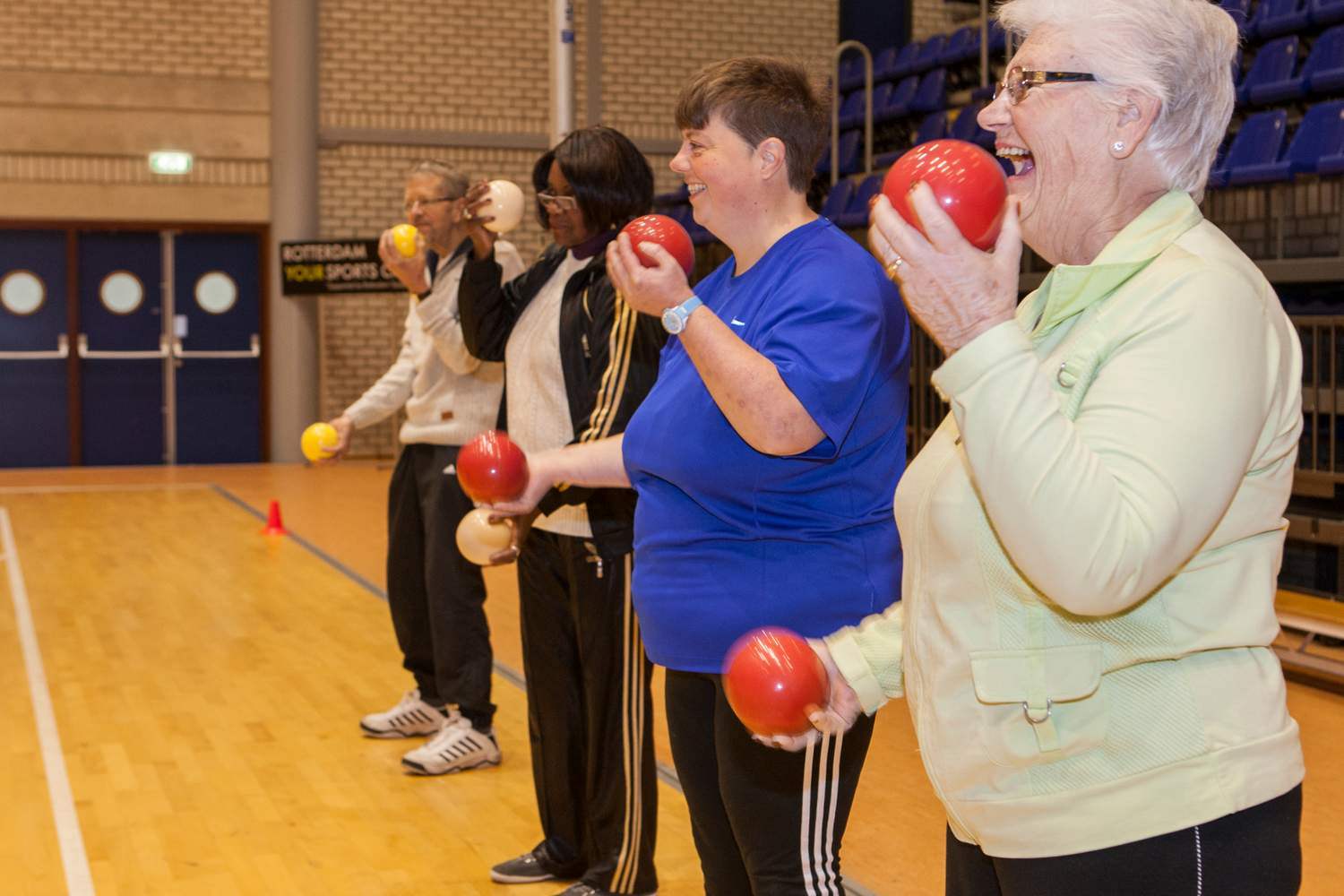 adult people excercising with weight balls