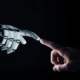 human and robot touching fingertips