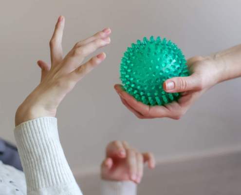 spikey plastic toy ball given to adult with cerebral palsy